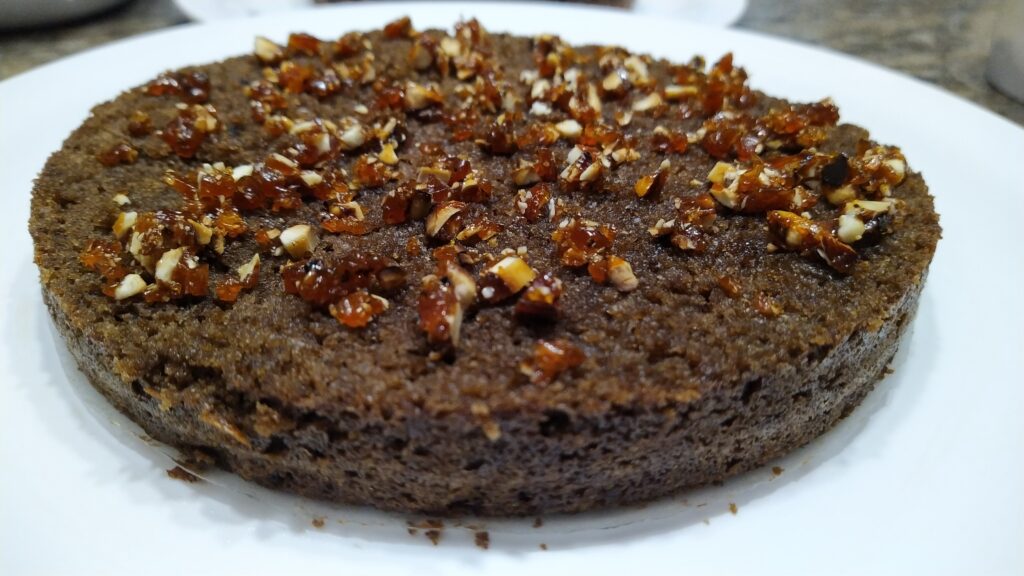 Sliced along the diameter brushed with rum flavoured simple syrup, topped with crushed praline.